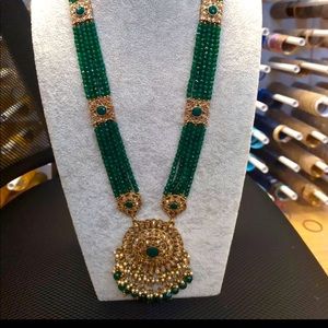 Long emerald green haar necklace by designer boutique